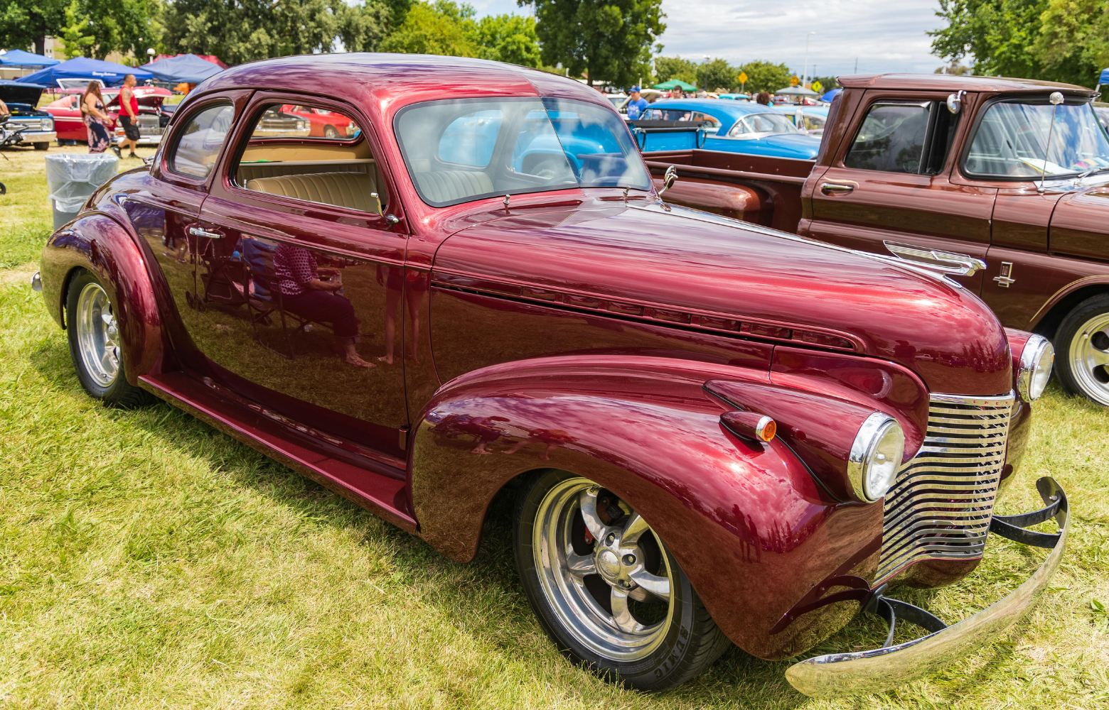 A classic car on display, showcasing its vintage design and timeless automotive craftsmanship at the Cavanaugh Carriages Car Show.