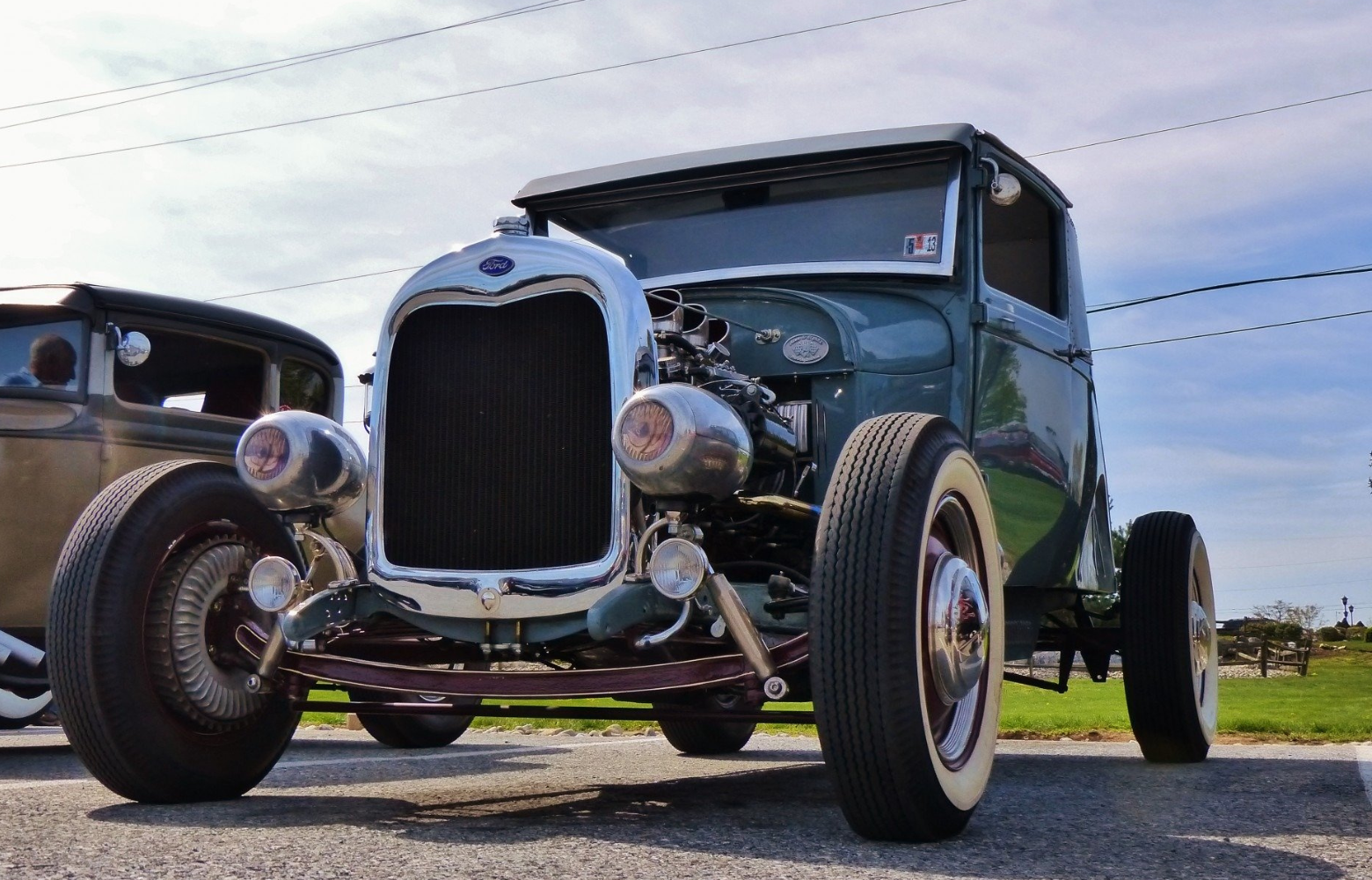 A classic car on display, showcasing its vintage design and timeless automotive craftsmanship at the Cavanaugh Carriages Car Show.