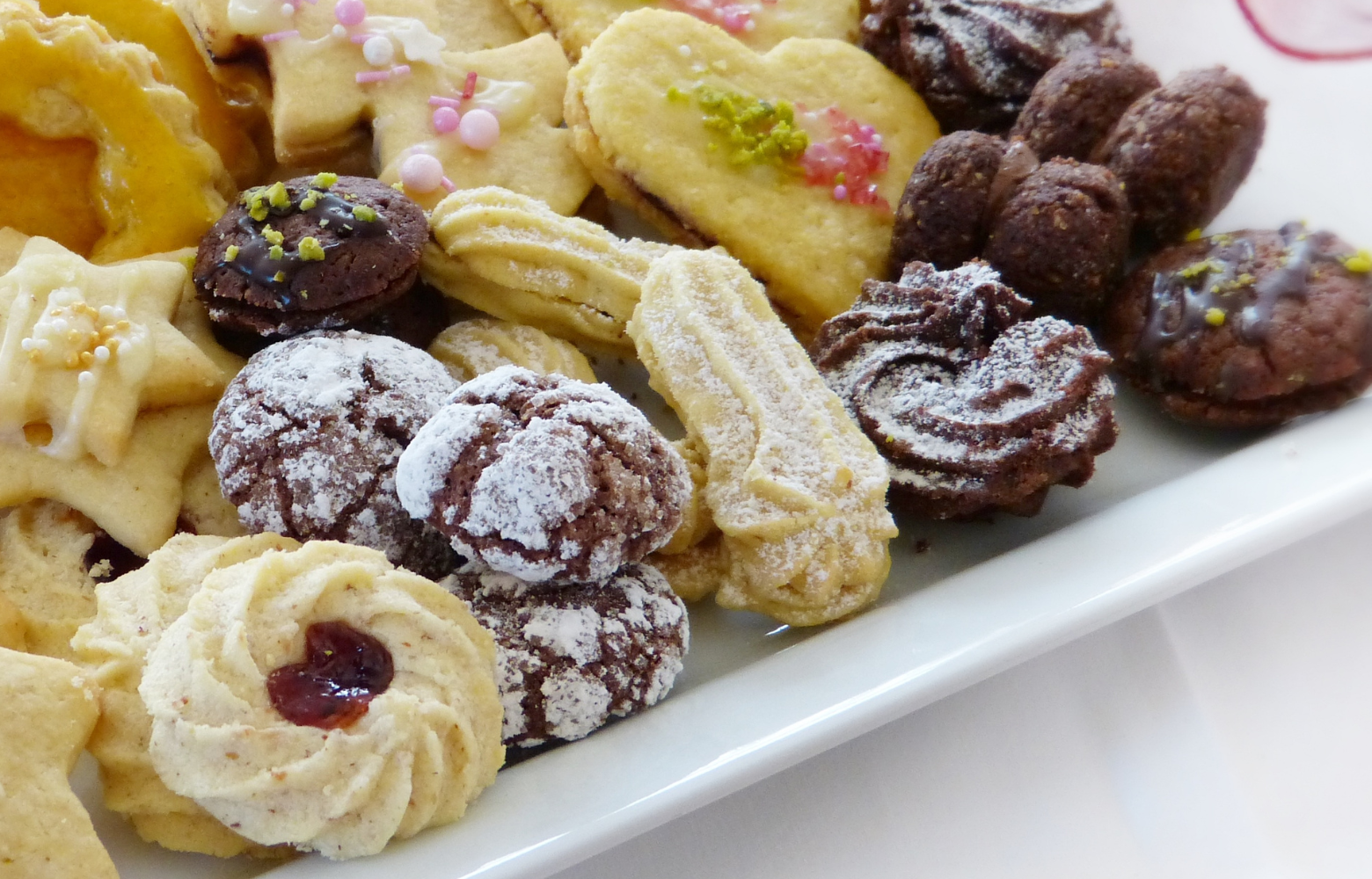 An assortment of festive holiday treats arranged on a table, featuring cookies, candies, and seasonal delights ready to be enjoyed.
