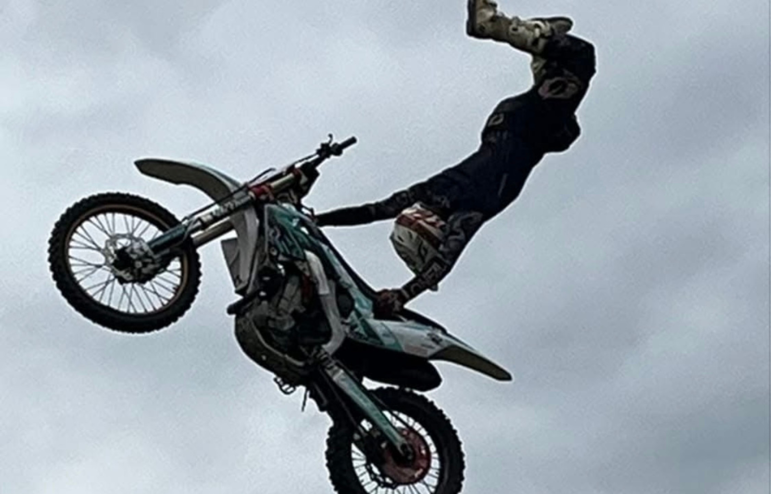 A high-energy FMX stunt, showcasing a rider soaring through the air while executing an adrenaline-pumping freestyle motocross trick.