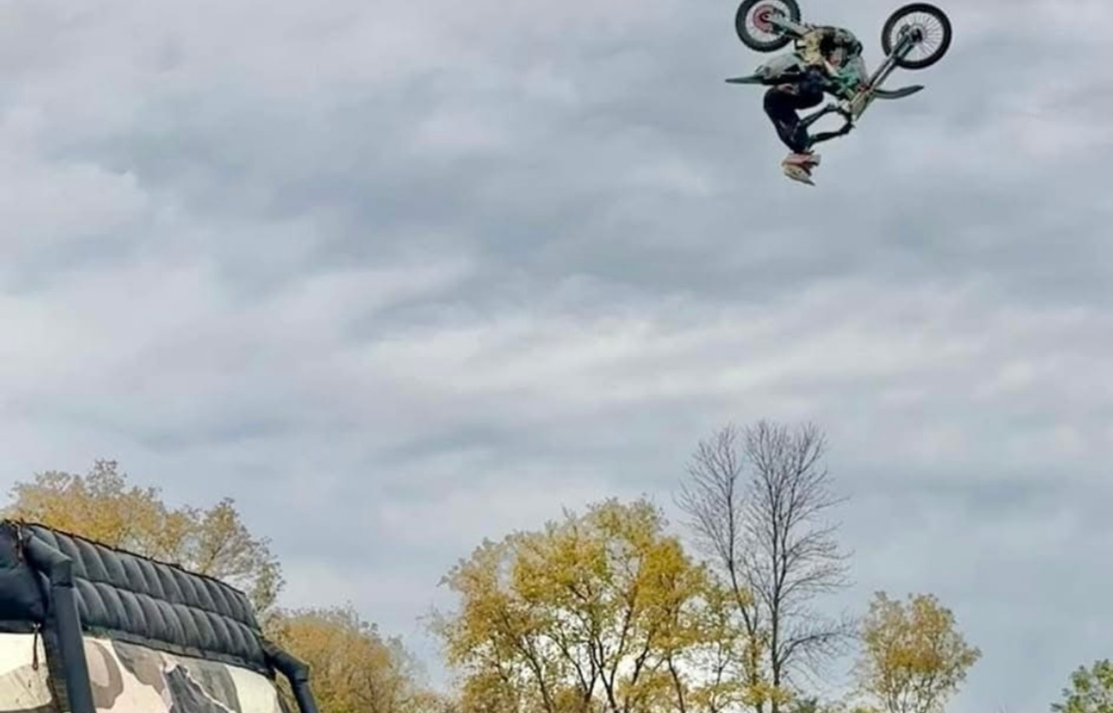 A high-energy FMX stunt, showcasing a rider soaring through the air while executing an adrenaline-pumping freestyle motocross trick.