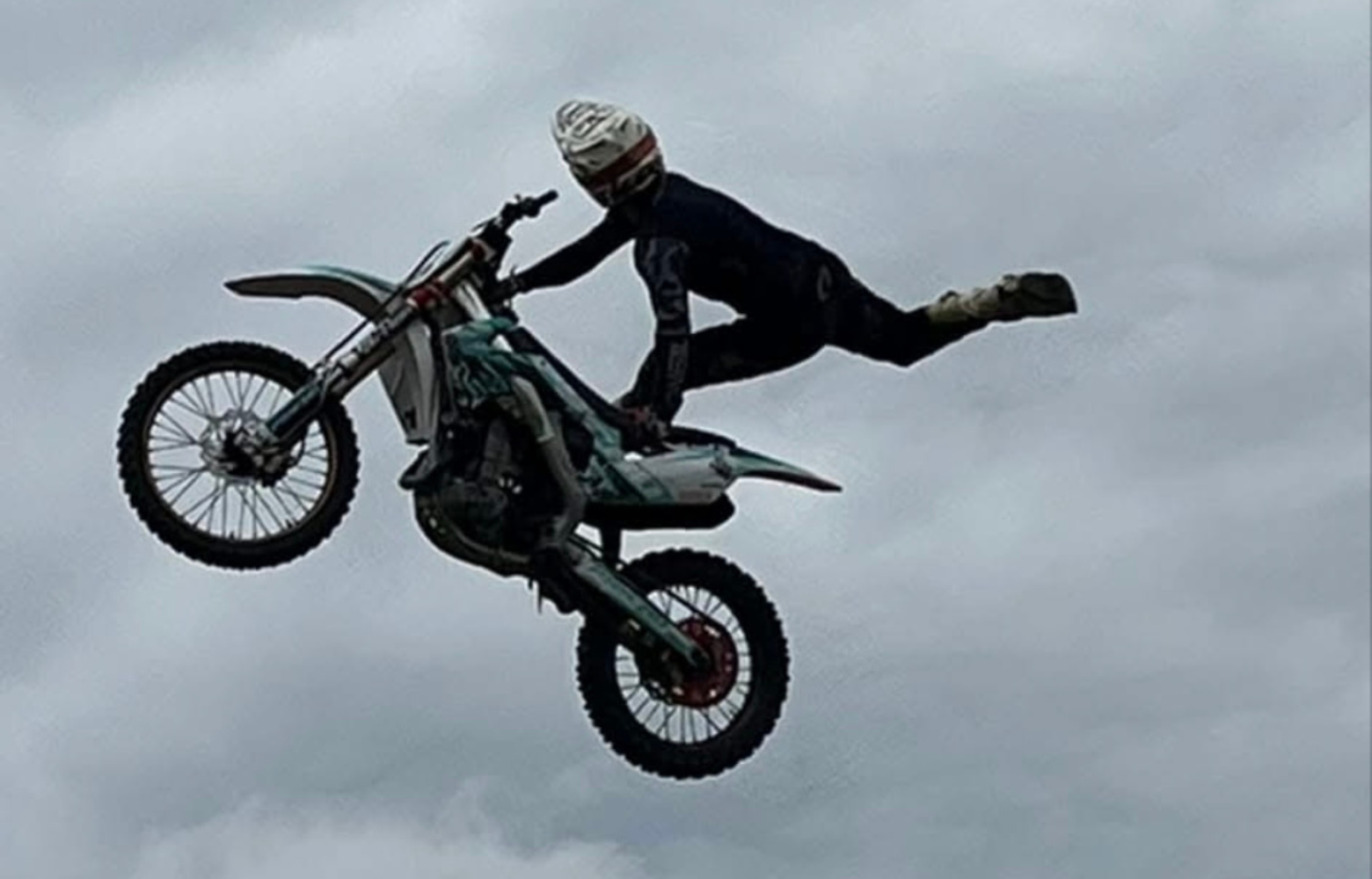 A high-energy FMX stunt, showcasing a rider soaring through the air while executing an adrenaline-pumping freestyle motocross trick.