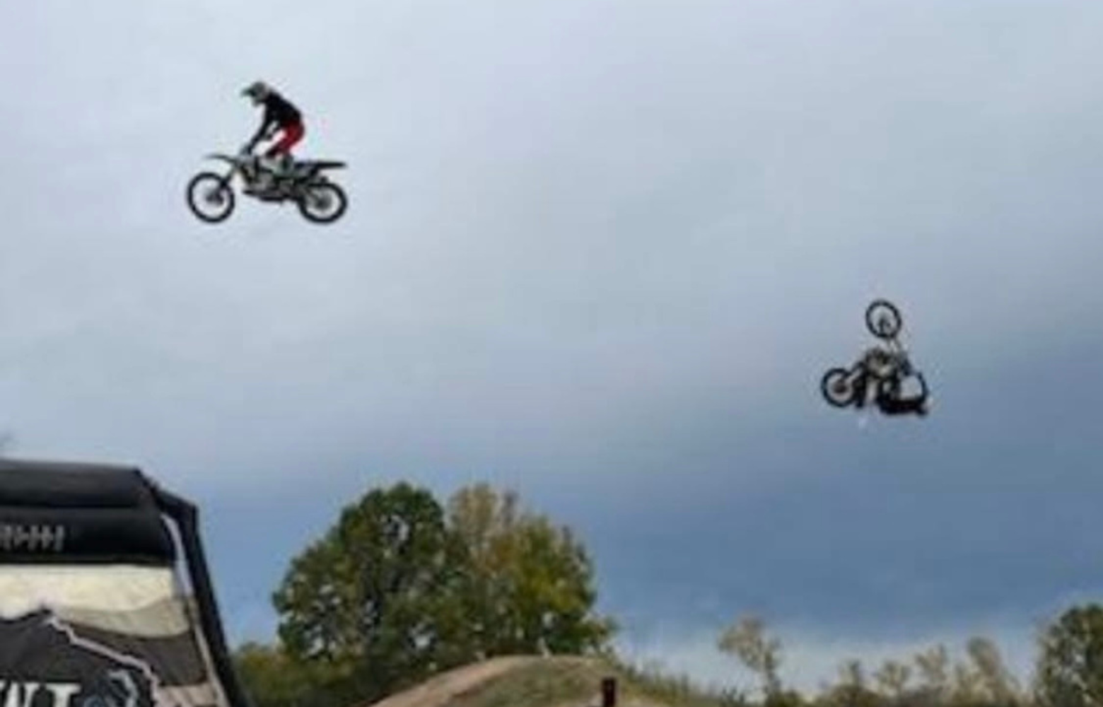 A high-energy FMX stunt, showcasing a rider soaring through the air while executing an adrenaline-pumping freestyle motocross trick.