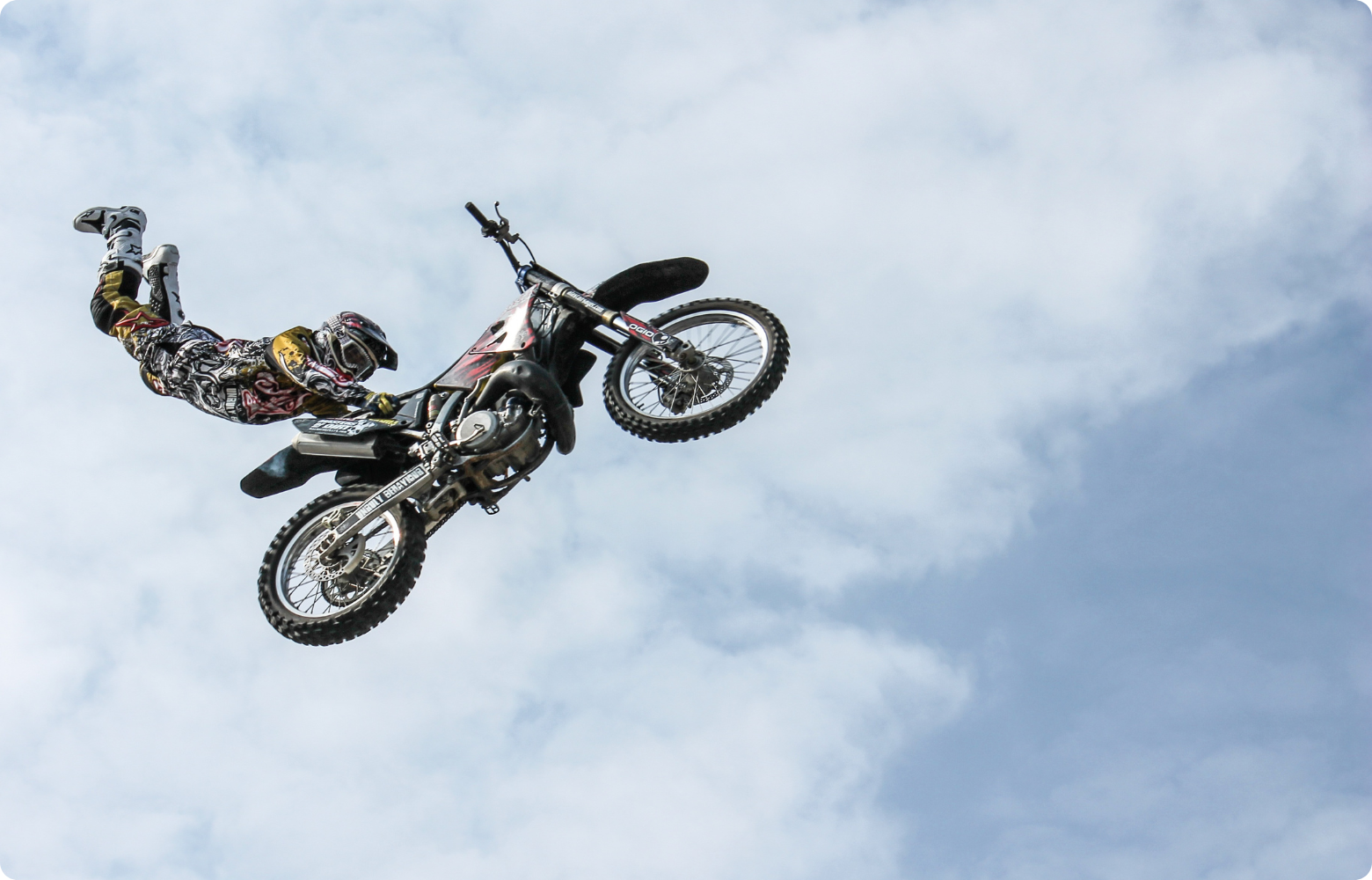 A high-energy FMX stunt, showcasing a rider soaring through the air while executing an adrenaline-pumping freestyle motocross trick.