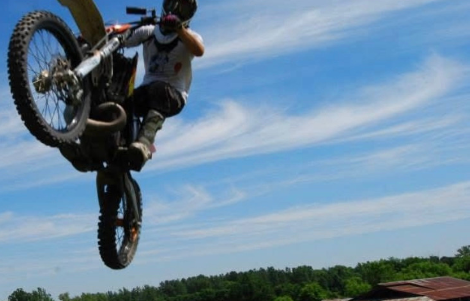 A high-energy FMX stunt, showcasing a rider soaring through the air while executing an adrenaline-pumping freestyle motocross trick.