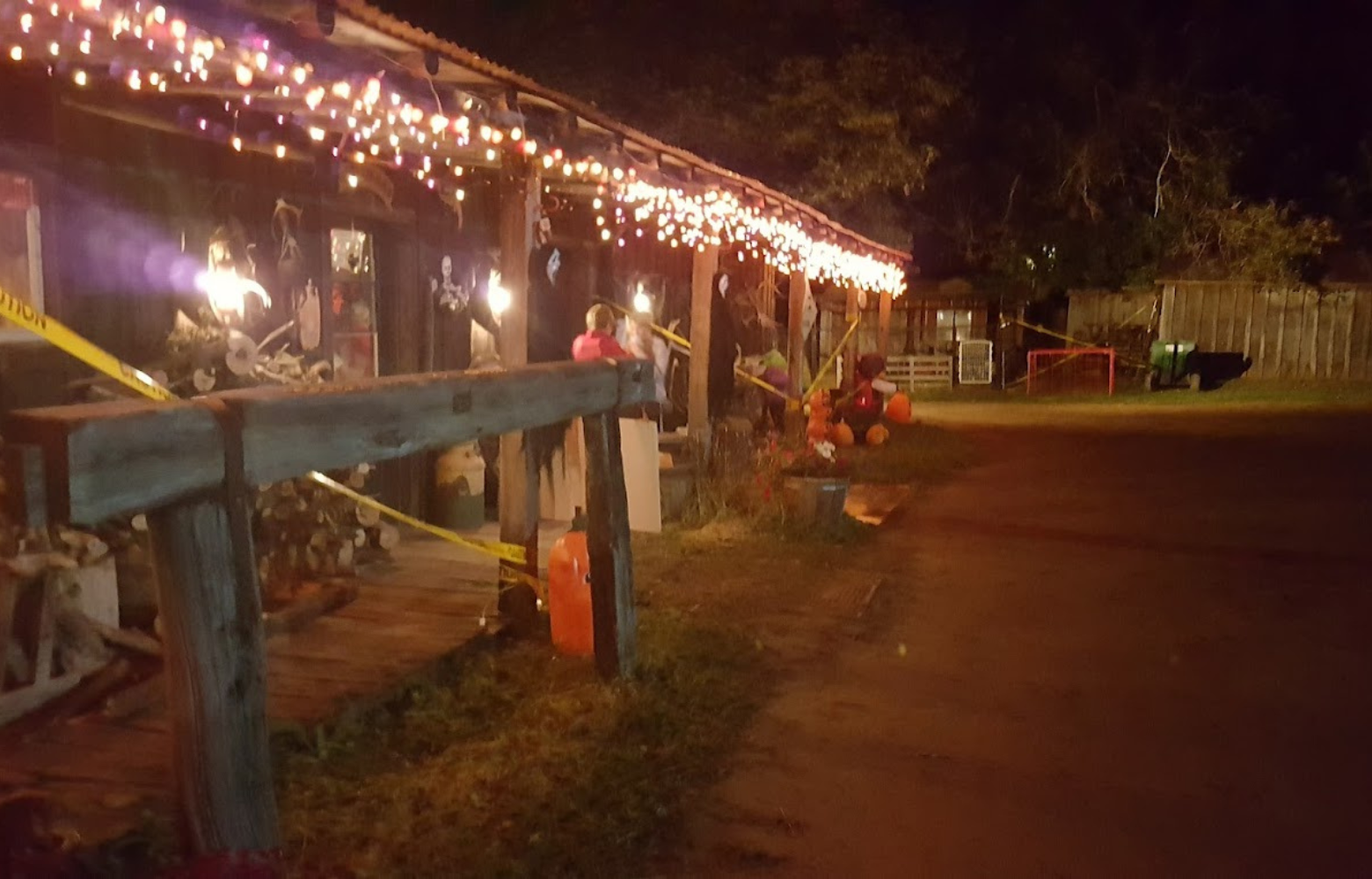 Cavanaugh’s Carriages barn and party room building illuminated and decorated for haunted hay rides, creating a festive and spooky atmosphere.
