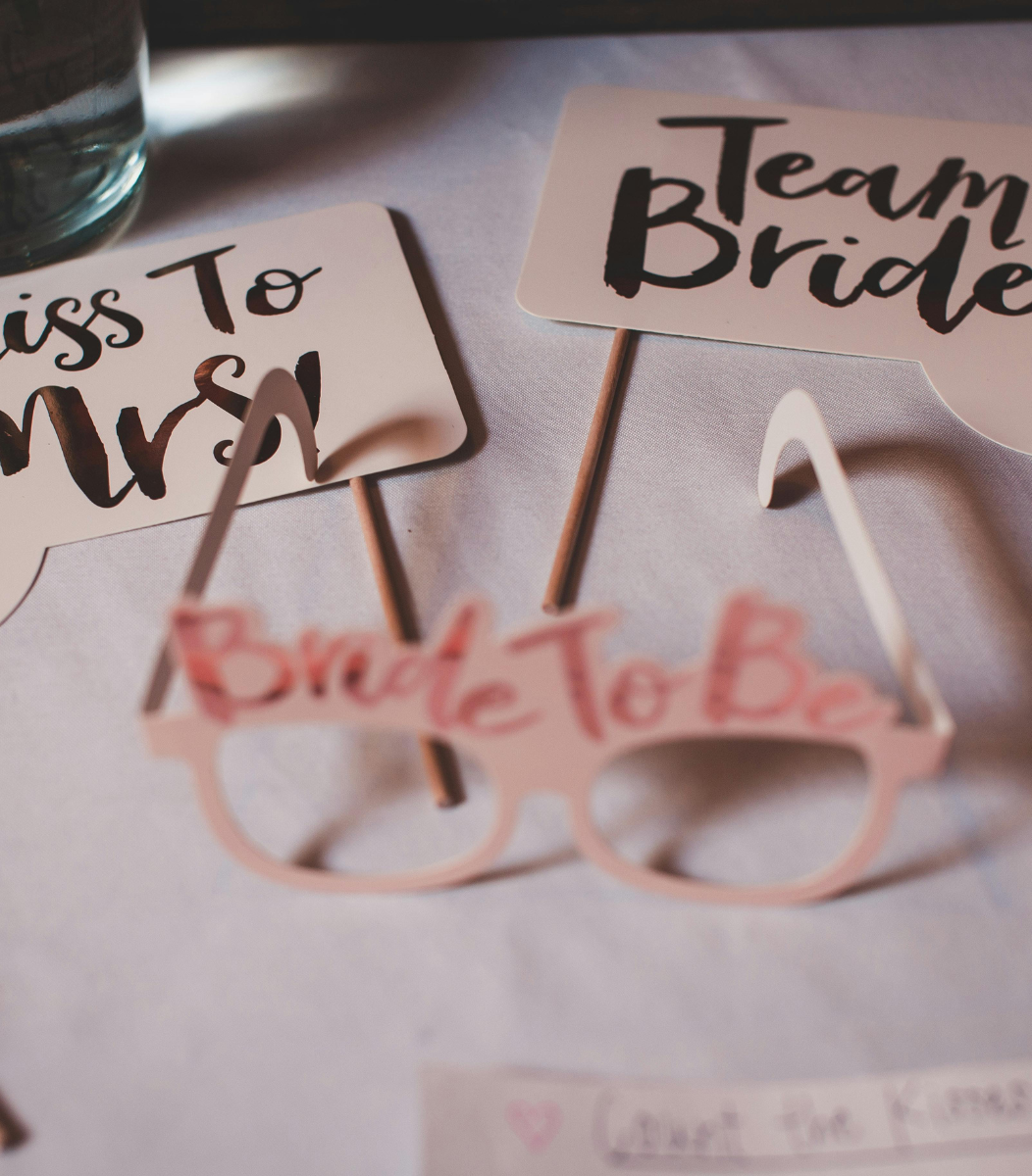 A festive bridal shower setup featuring 'Miss to Mrs.' decorations, 'Team Bride' items, and fun bridal accessories, showcasing Cavanaugh Carriages' event services for special occasions