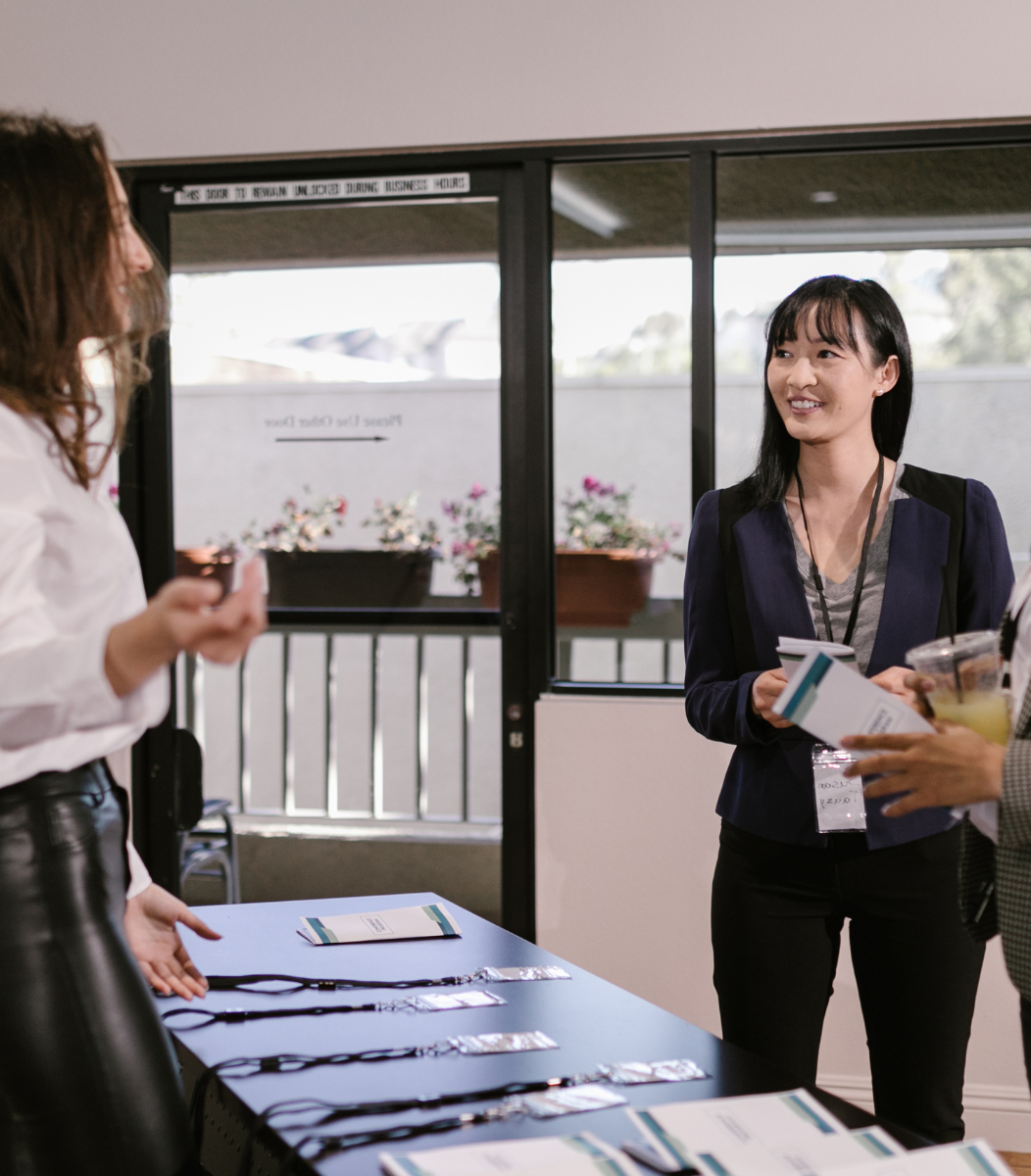 A trade show booth with people engaging in conversations and exploring the exhibits, showcasing the dynamic atmosphere of events hosted by Cavanaugh Carriages