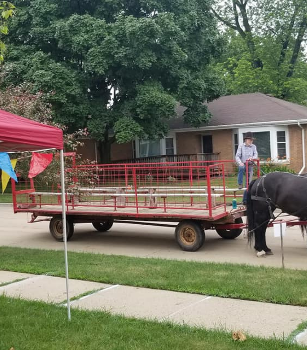 Rodger Cavanaugh engaging with attendees at a lively community event, showcasing his connection and involvement in local activities hosted by Cavanaugh Carriages