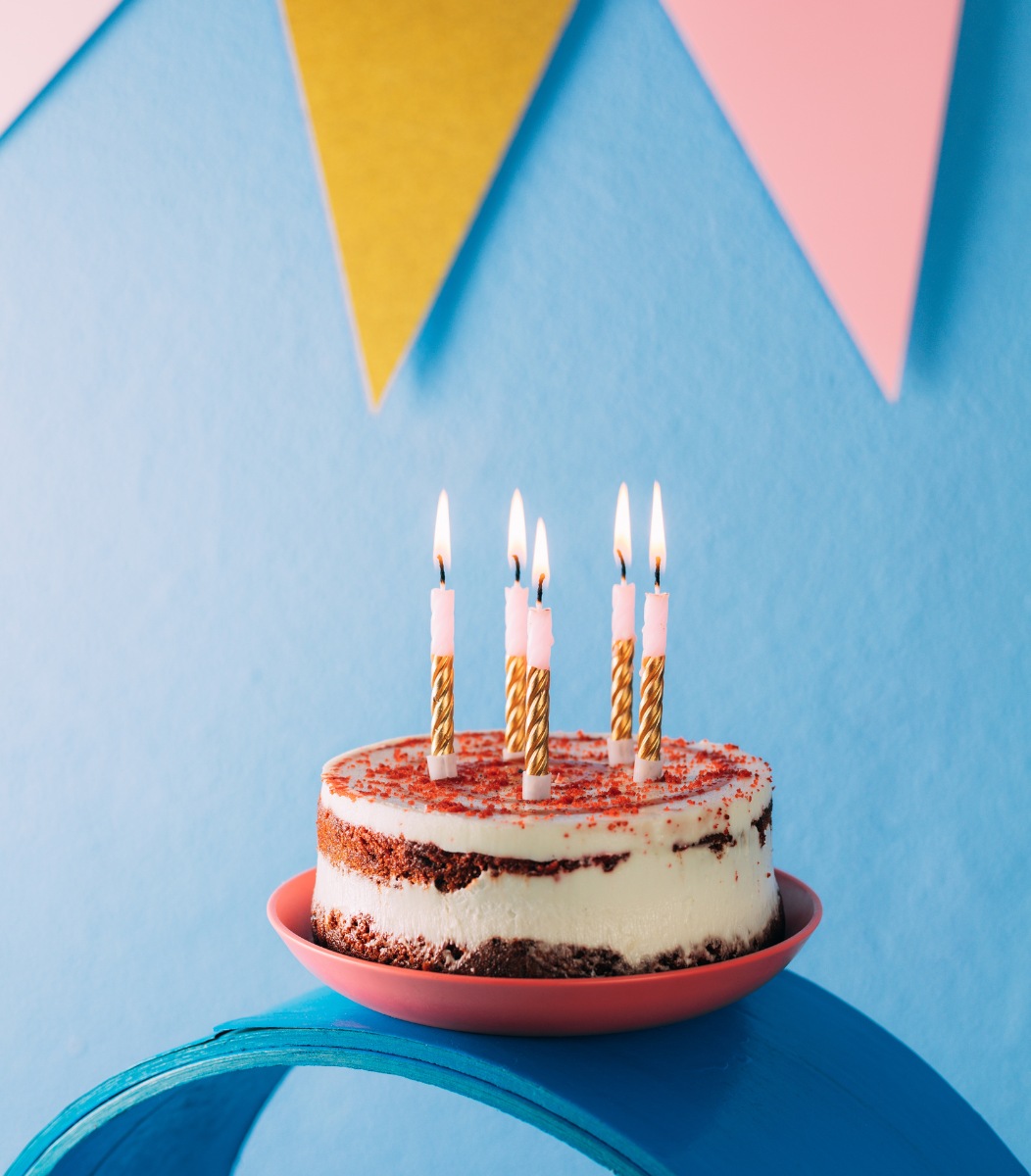 A colorful birthday cake decorated with candles and festive designs, celebrating joyful moments with Cavanaugh Carriages